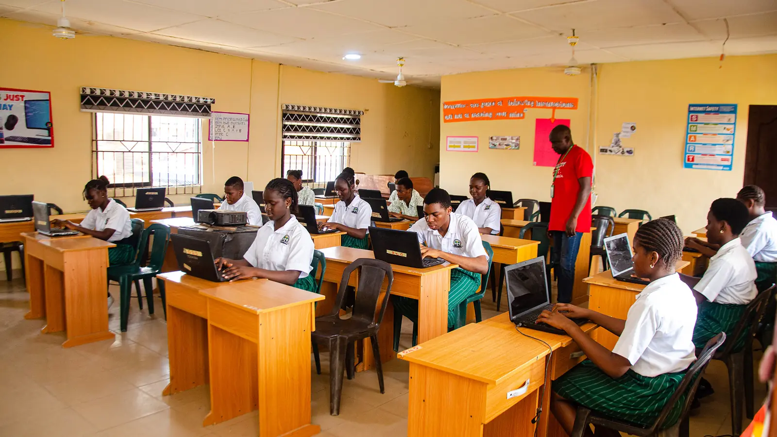 Students working on laptops in the Palmville ICT laboratory
