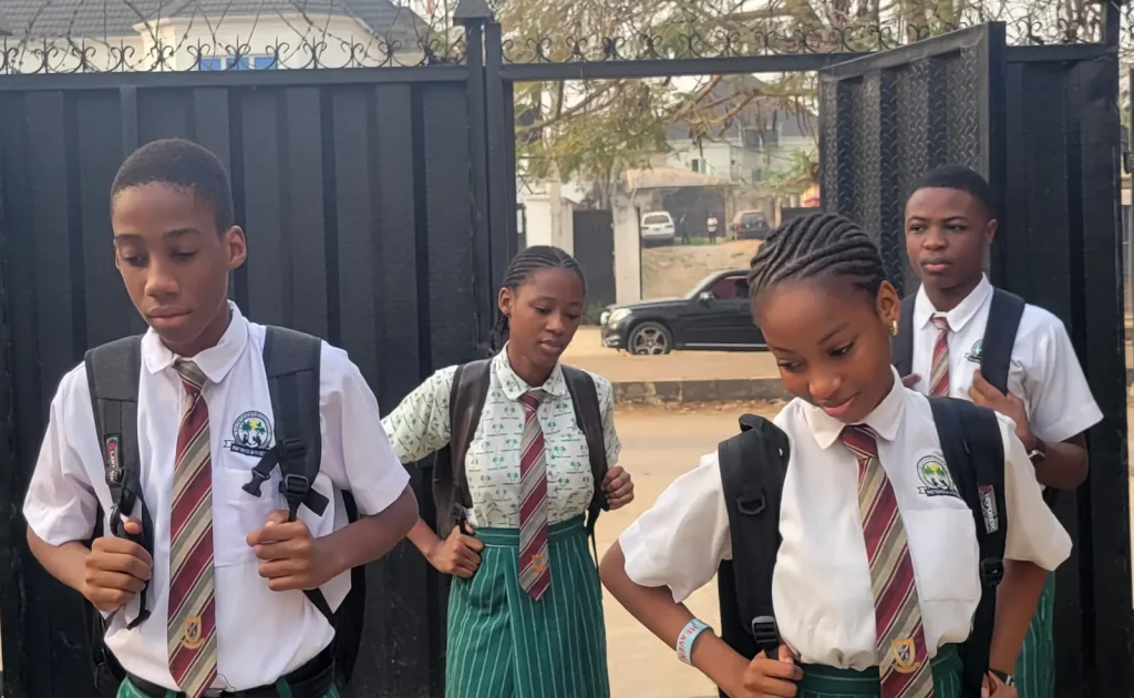 Palmville College students arriving at the school gate