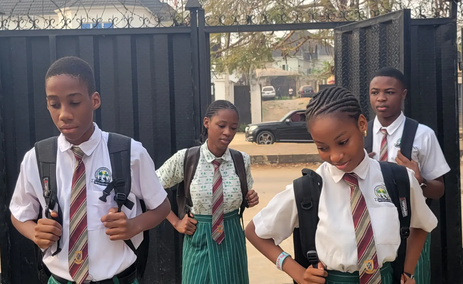 Palmville College students arriving at the school gate